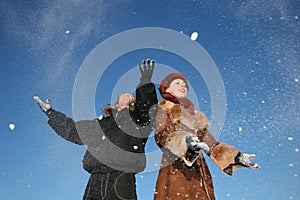 Winter couple throw snow