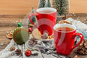 Winter cozy composition with hot tea and traditional Christmas decoration. New Year balls