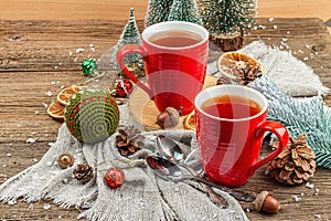 Winter cozy composition with hot tea and traditional Christmas decoration. New Year balls