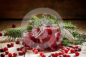 Winter cranberry sauce in glass jars with fresh cranberries, dec