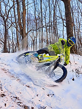 Winter cycling. Extreme riding on a mtb, mountain bicycle in the snow in the winter forest.