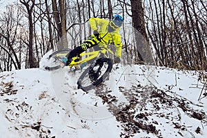Winter cycling. Extreme riding on a mtb, mountain bicycle in the snow in the winter forest.