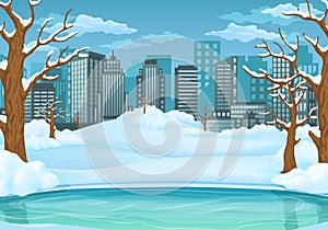 Winter day background. Frozen lake or river with snow covered leafless trees and bushes. Cityscape in the background
