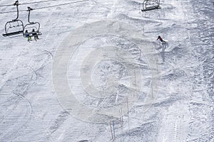 Winter day on a ski resort in Europe. Beautiful texture created by skiers descending the mountain. Ski lift on the slop