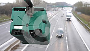 Winter day view average speed traffic camera under falling snow over UK Motorway