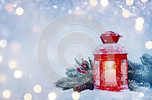 Winter decoration background of Christmas snowed lantern and fir branch photo