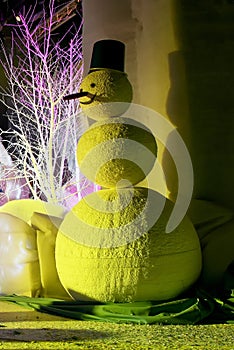 A winter decoration with a big snowman from papier mache indoors