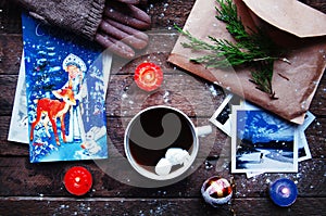 Winter decoration. Composition on wood background. Hot tea, candles, cut grapefruit. Christmas. Christmas mood. Christmas spirit.