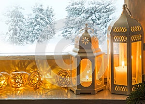 Winter decoration with lanterns on windowsill