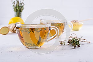 Winter drink. Warming hot tea with lemon, ginger, and herbs thyme,