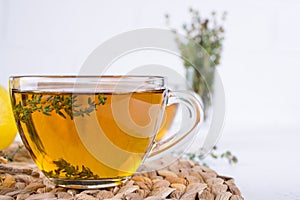 Winter drink. Warming hot tea with lemon, ginger, and herbs thyme,