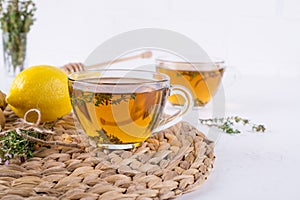 Winter drink. Warming hot tea with lemon, ginger, and herbs thyme,