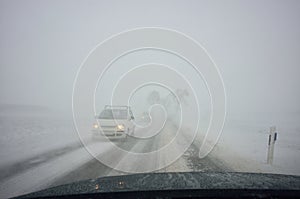 Winter driving by blizzard photo