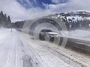 Winter driving on a highway with falling snow. The car is driving on a winter road in a blizzard