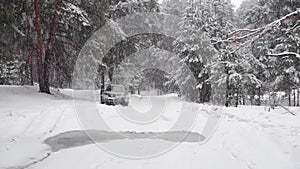 Winter driving. Off-road riding on winter forest snowy road. One suv car standing country road in winter forest with