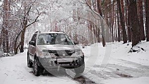 Winter driving. Off-road riding on winter forest snowy road. One suv car standing country road in winter forest with