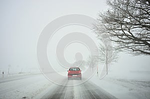 Winter driving by snowstorm poor visibility photo