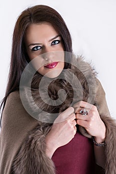 Winter Elegance: Fashion Studio Portrait of a Beautiful Woman in a Brown Fur Coat