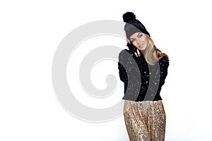 Winter elegant fashion. Beautiful young elegant woman in winter sequin outfit isolated on white background in studio. The model is