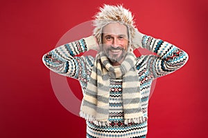 A winter ensemble protects him from cold. Mature fashion model enjoys cold weather style. Bearded man accessorizing