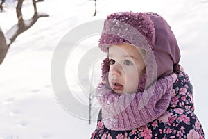 Winter, family, childhood concepts - close-up portrait authentic little preschool minor girl in pink look around in