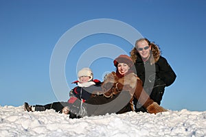 Winter family sit on snow