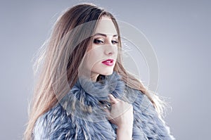 Winter fashion woman in a fur coat.