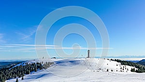 Winter Feldberg Ski Resort in Black Forest of German, tower at rear of treeless area photo
