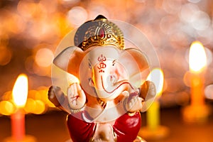 Winter festivals in India with Lord Ganesha statue and candles