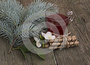 Winter festive card, tea, fir-tree branch, cookies and flower