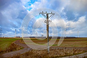 Winter field. On the horizon are visible wind power generators