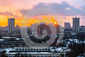 Winter fiery dawn over the city. Panoramic view of a modern residential area and a delightful sky in the background.