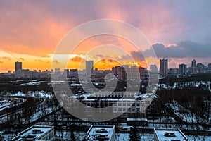 Winter fiery dawn over the city. Panoramic view of a modern residential area and a delightful sky in the background.