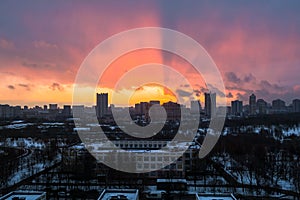 Winter fiery dawn over the city. Panoramic view of a modern residential area and a delightful sky in the background.