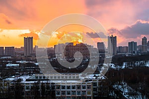 Winter fiery dawn over the city. Panoramic view of a modern residential area and a delightful sky in the background.