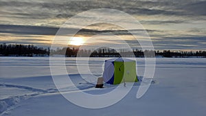 Winter fishing catch. Fish with rod and hole in ice on background