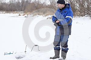 Winter fishing, a man on a winter river