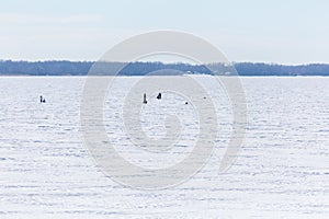 Winter fishing on the river or lake. The fishermen on the ice