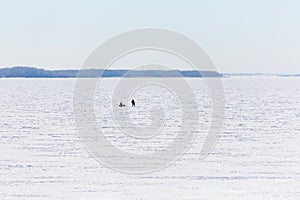 Winter fishing on the river or lake. The fishermen on the ice