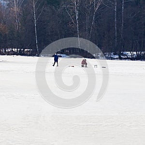 Winter fishing. River, lake near forest in ice. Anglers, Fishermens during your favorite leisure time. Copy space