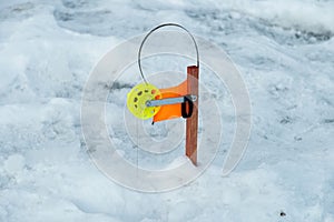 Winter fishing rod and ice hole close up