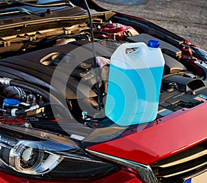 Winter fluid refilling in car. Winter service for safe driving.