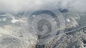 Winter forest from above. Winter mountains landscape. Trees covered with snow and frost. Fog above mountains. 2 videos