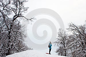 Winter forest with a figure of a girl admiring nature