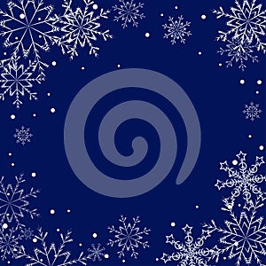 Winter frame of white snowflakes on dark blue background with copy space