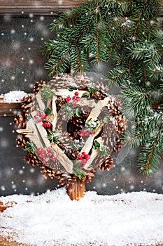 Winter  frost window with round wreath, Christmas  or Advent time