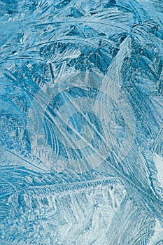 Winter frosty patterns on glass. Christmas festive background. Ice crystals on window.