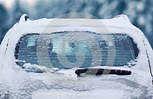 Winter frozen back car window, texture freezing ice glass