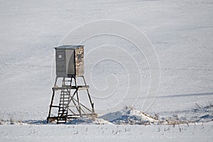 Winter frozen landscape with hunting tower on highland