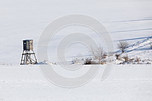 Winter frozen landscape with hunting tower on highland